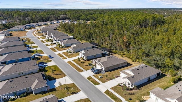 aerial view featuring a forest view and a residential view