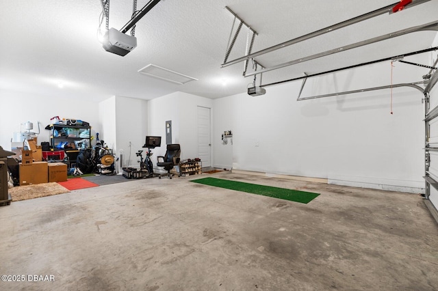 garage with a garage door opener and electric panel