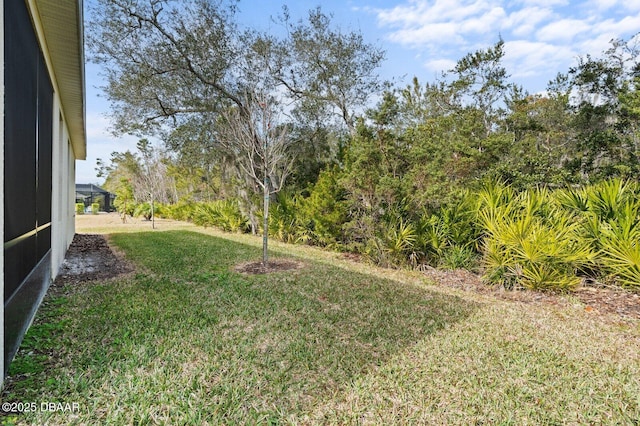 view of yard with glass enclosure