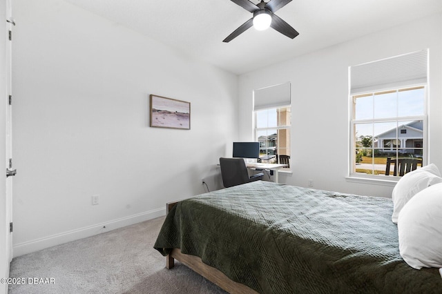 carpeted bedroom with baseboards and a ceiling fan