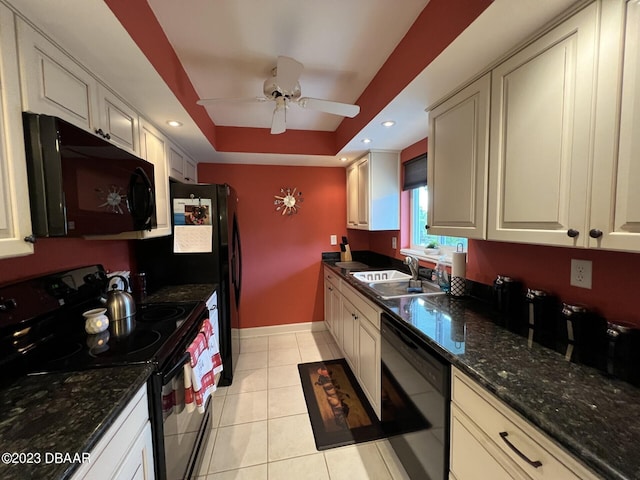 kitchen featuring ceiling fan, light tile patterned flooring, black appliances, a raised ceiling, and a sink