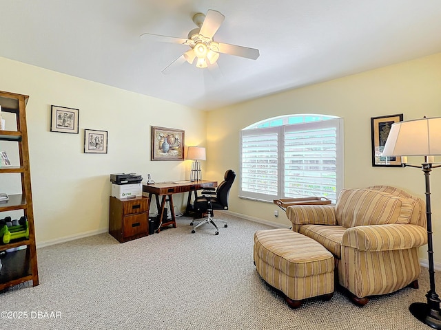 carpeted office space featuring ceiling fan