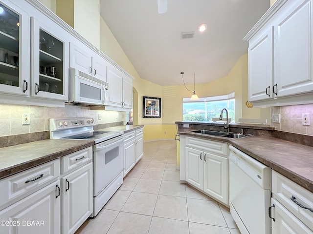 kitchen featuring white cabinetry, sink, and white appliances