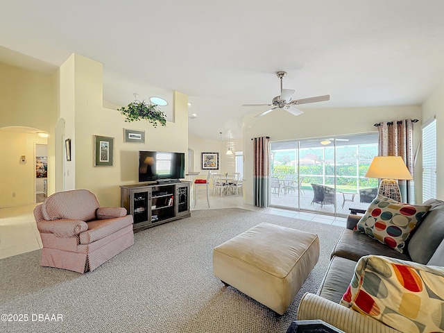 carpeted living room featuring ceiling fan and high vaulted ceiling