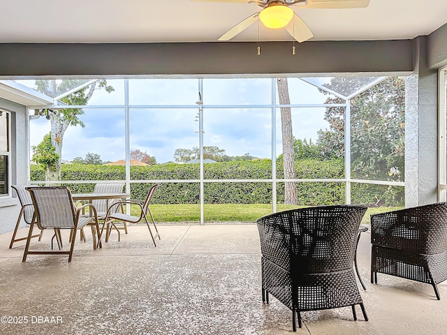 sunroom featuring ceiling fan