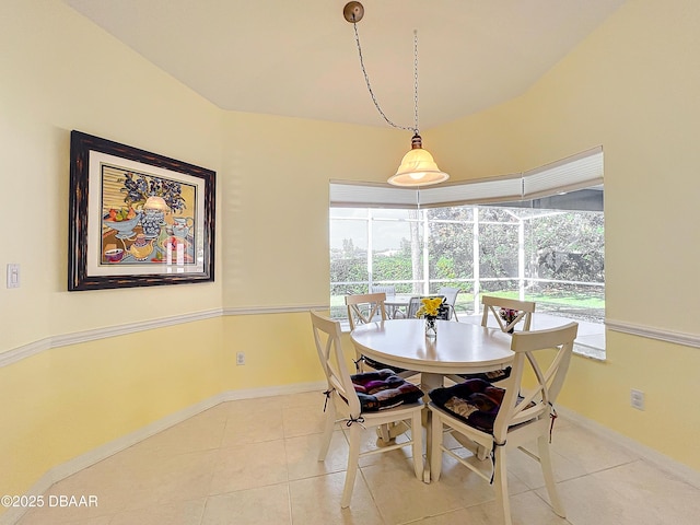 dining space with a wealth of natural light and light tile patterned flooring