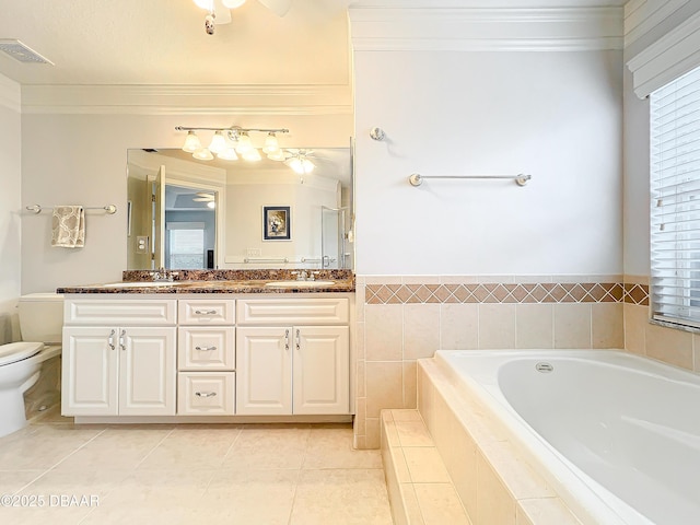 bathroom with tile patterned flooring, vanity, and tiled bath