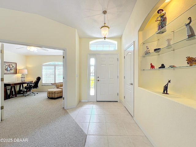 tiled entryway featuring ceiling fan