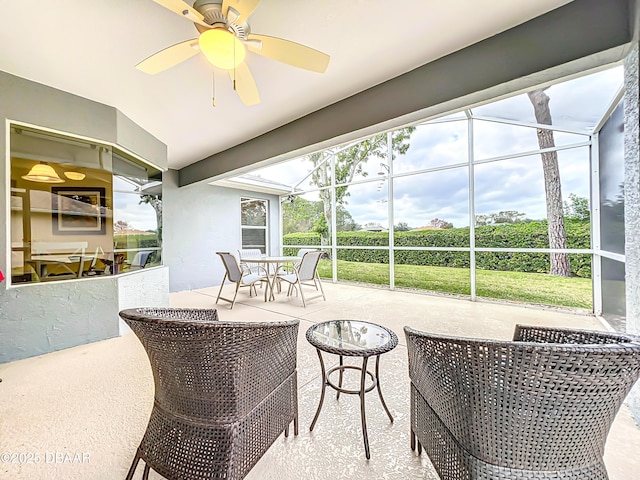 sunroom / solarium featuring ceiling fan