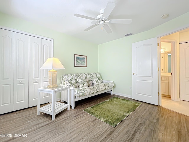 living room with ceiling fan and hardwood / wood-style flooring