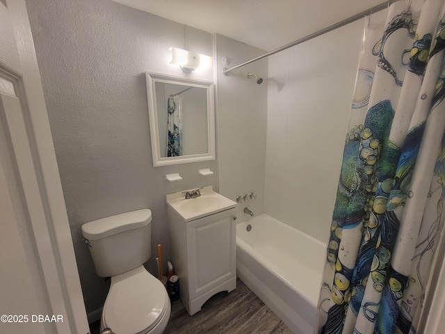 bathroom featuring wood finished floors, vanity, toilet, and shower / bath combo with shower curtain