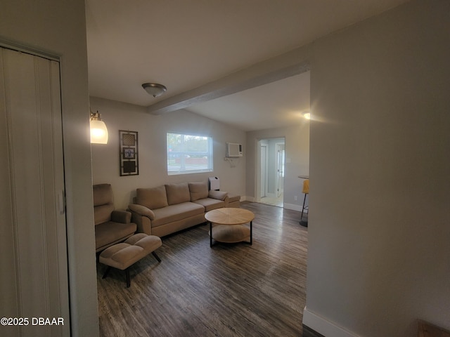 living room featuring lofted ceiling with beams, an AC wall unit, wood finished floors, and baseboards