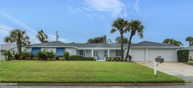 single story home with a garage and a front yard