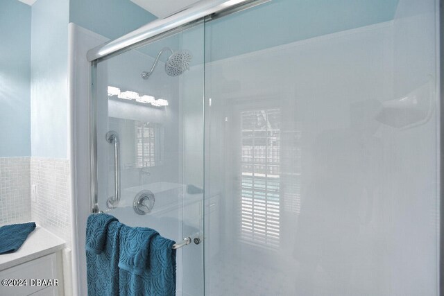 bathroom with vanity and a shower with shower door