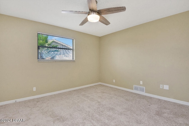 unfurnished room featuring light carpet and ceiling fan