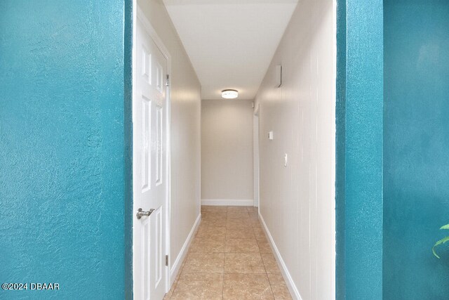 hallway with light tile patterned floors