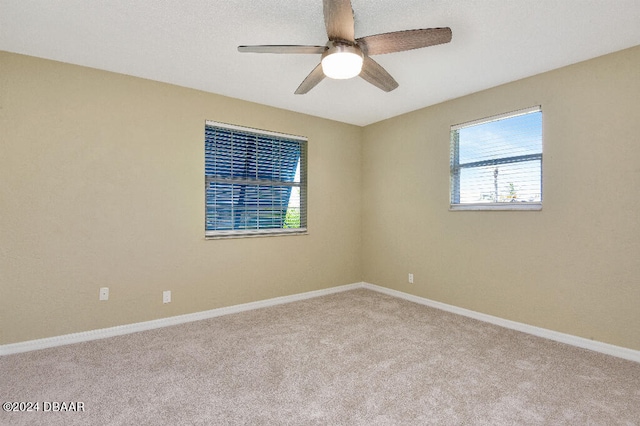 unfurnished room featuring light carpet and ceiling fan