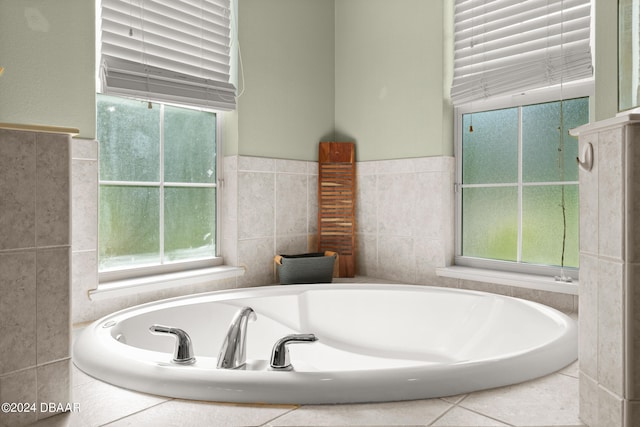 bathroom featuring a tub to relax in, tile walls, and plenty of natural light