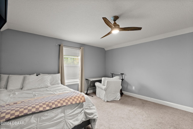 bedroom featuring a textured ceiling, carpet, and ceiling fan