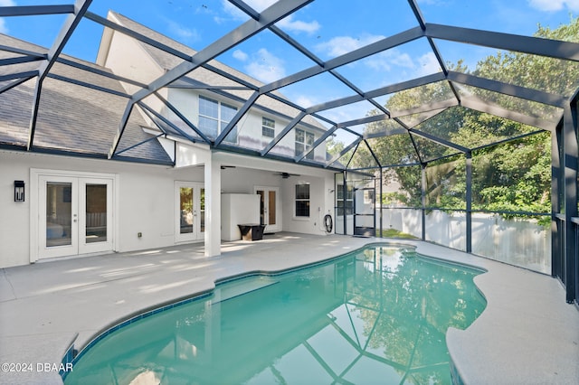 view of pool featuring a lanai, french doors, ceiling fan, and a patio area