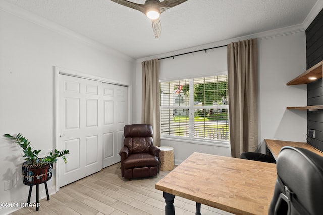 office area featuring a textured ceiling, light hardwood / wood-style flooring, ceiling fan, and crown molding