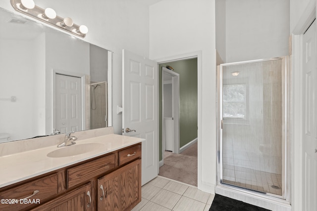 bathroom featuring vanity, tile patterned floors, and a shower with shower door