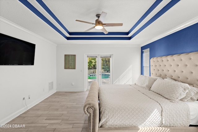 unfurnished bedroom featuring light hardwood / wood-style floors, ceiling fan, a raised ceiling, french doors, and access to outside