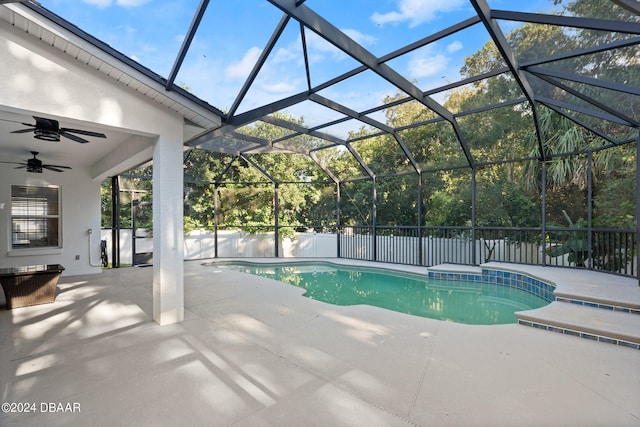 view of pool with ceiling fan, a patio, and a lanai