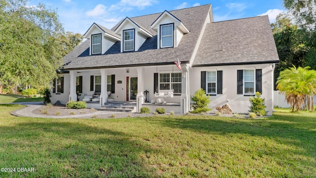 rear view of property featuring a porch and a yard