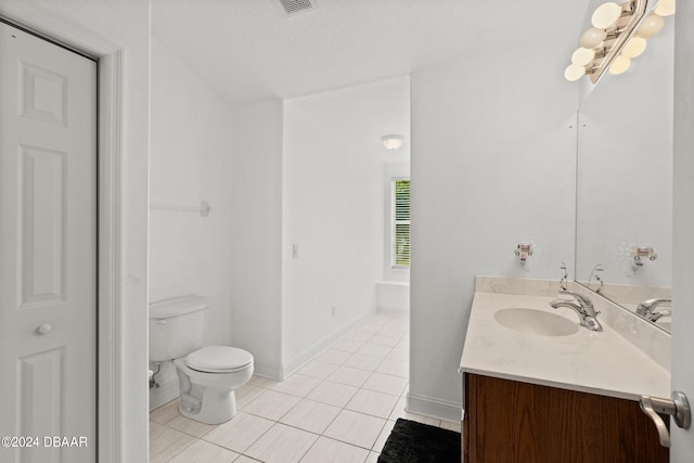 bathroom with a bath, vanity, a textured ceiling, tile patterned flooring, and toilet