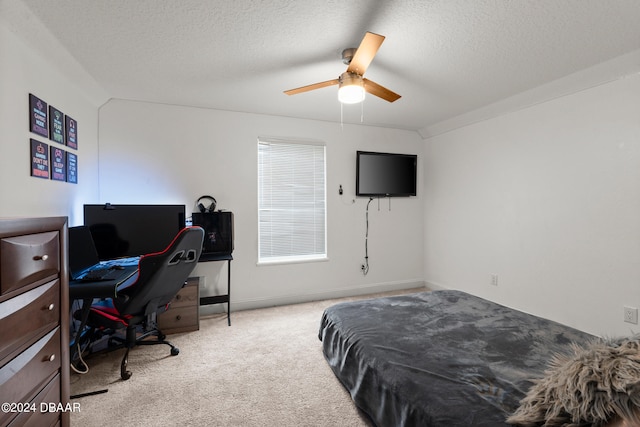 bedroom with ceiling fan, a textured ceiling, and light carpet