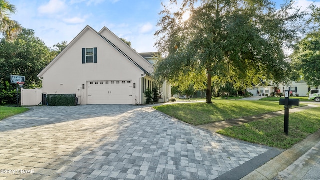 view of front facade featuring a garage and a front lawn