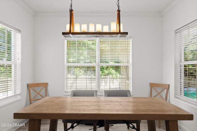 dining room featuring a chandelier, a wealth of natural light, and crown molding