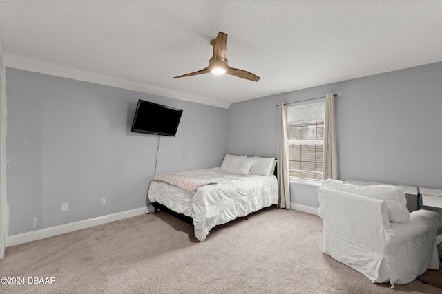 carpeted bedroom with a textured ceiling and ceiling fan