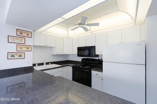 kitchen featuring black appliances, dark countertops, a sink, and white cabinetry