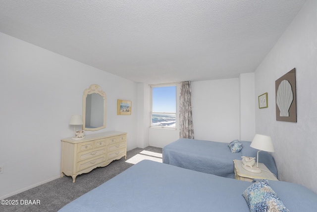 bedroom with carpet and a textured ceiling