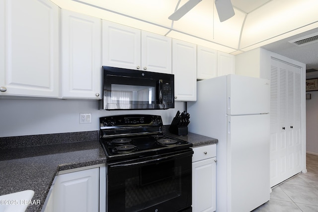 kitchen with dark countertops, white cabinets, and black appliances