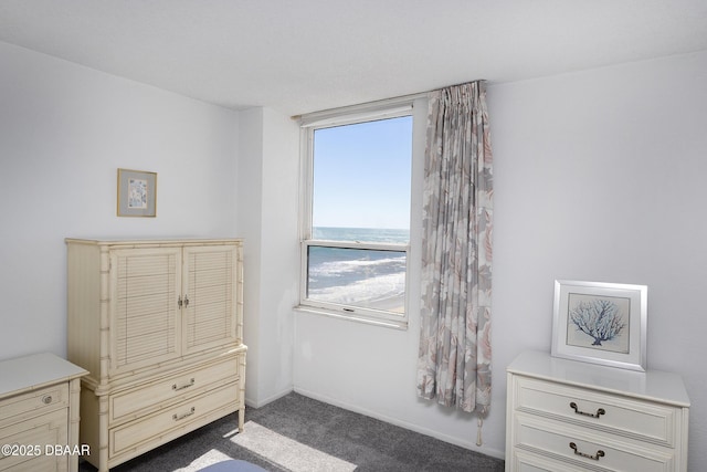 carpeted bedroom featuring baseboards