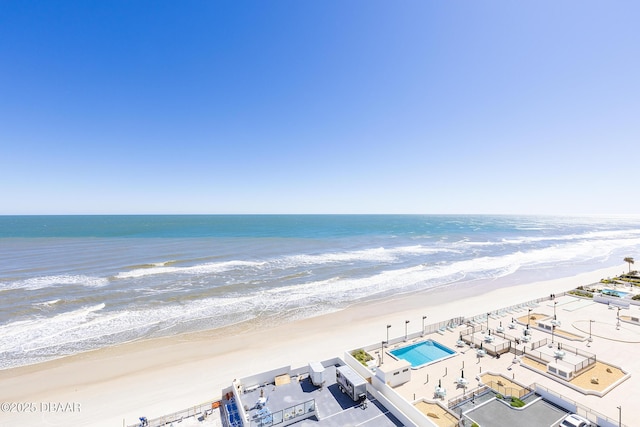 birds eye view of property featuring a water view and a beach view