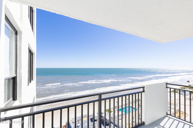 balcony with a beach view and a water view