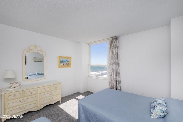 carpeted bedroom featuring a textured ceiling