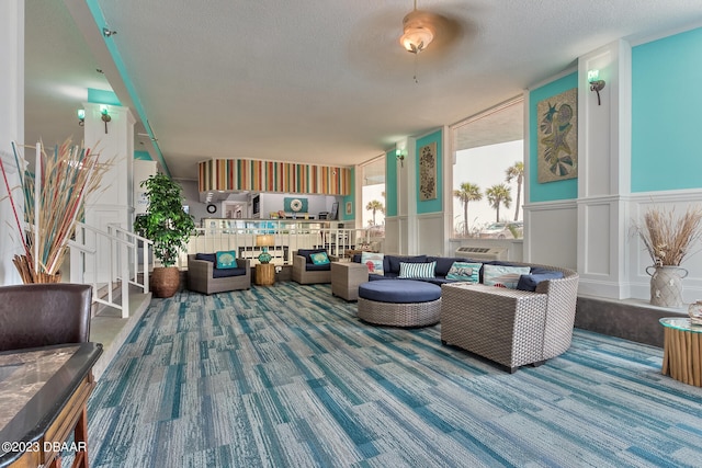 living room featuring a textured ceiling and carpet floors