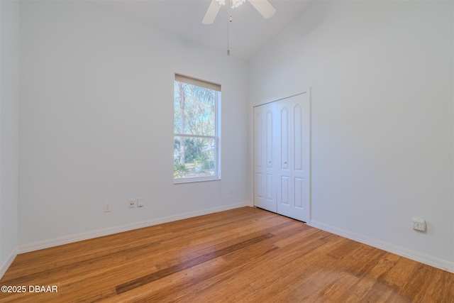 empty room featuring vaulted ceiling, ceiling fan, and light wood-type flooring