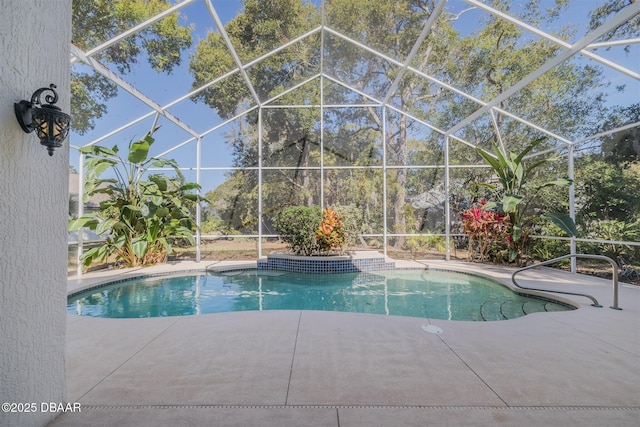 view of pool featuring a patio and glass enclosure