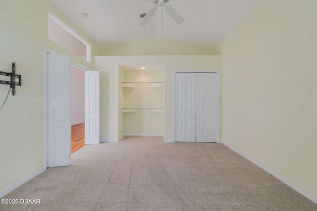 unfurnished bedroom with vaulted ceiling, light colored carpet, and ceiling fan