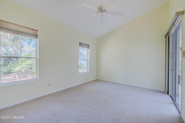 carpeted spare room featuring ceiling fan