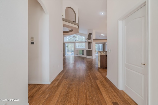 corridor featuring hardwood / wood-style flooring and a high ceiling