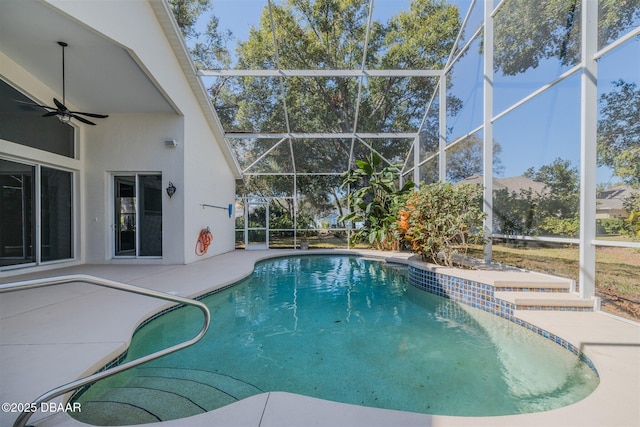 view of pool featuring a patio area, ceiling fan, and glass enclosure