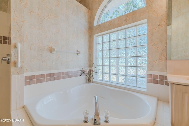 bathroom with vanity and tiled bath