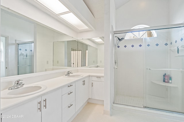 bathroom featuring walk in shower, tile patterned flooring, and vanity